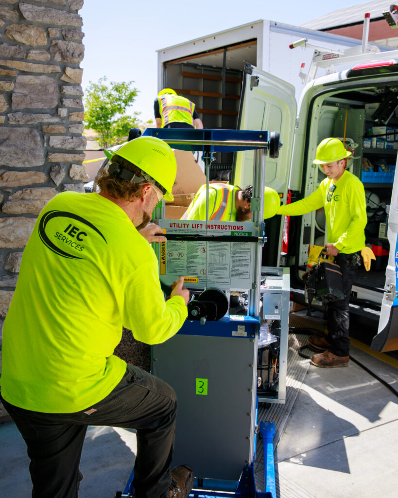 construction workers loading a van with equipment